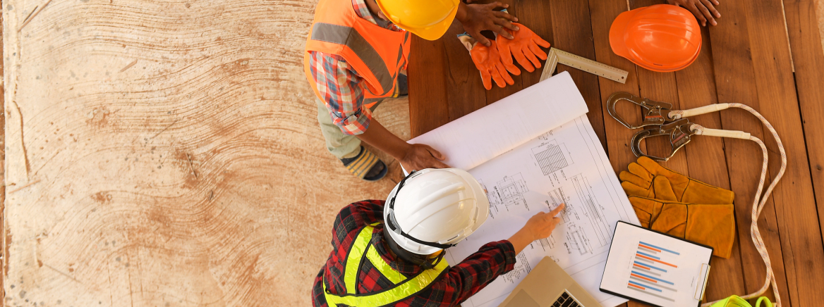Top view of architectural engineer working on his blueprints with documents on construction site.focus on shirt engineer.Team of young man and woman engineer and architects working., ​​​​​​​​Air Quality Permitting and Enforcement Forms
