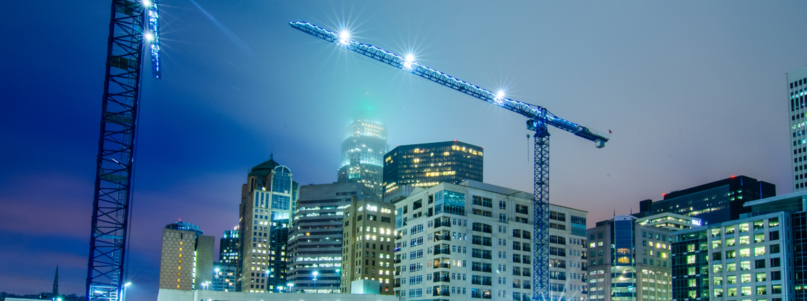 Cranes and scaffolding working on high-rises in Uptown Charlotte.